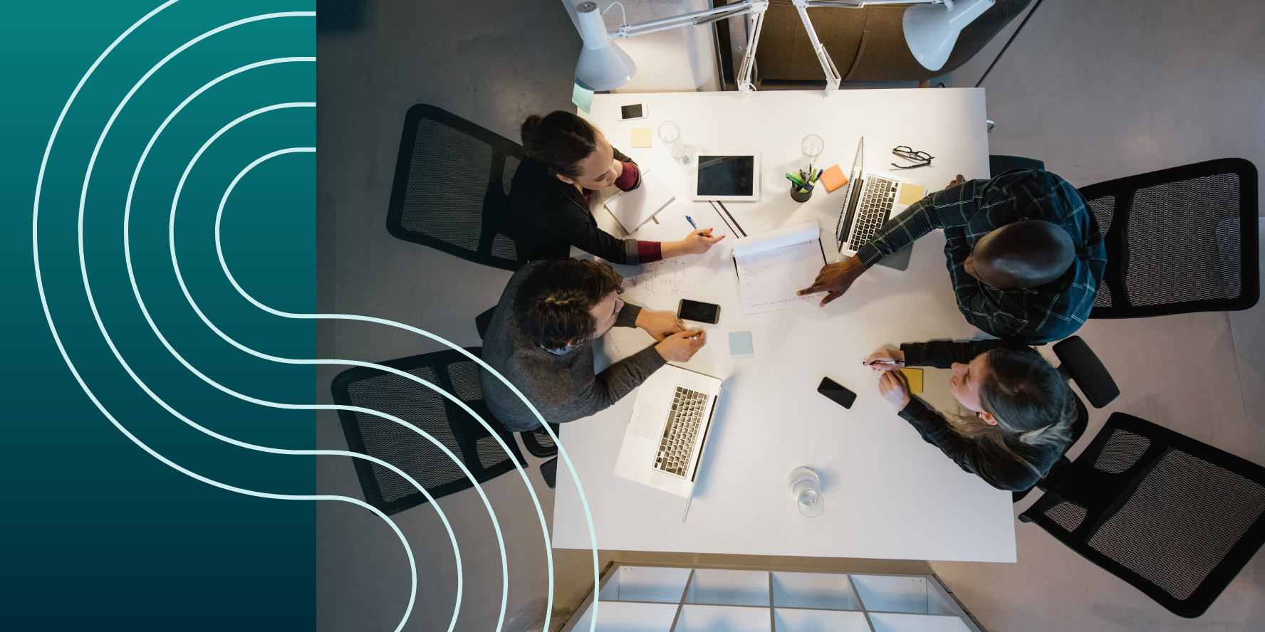 Four professionals collaborate at a white table with laptops and documents, captured from above. Geometric lines overlay on the left.